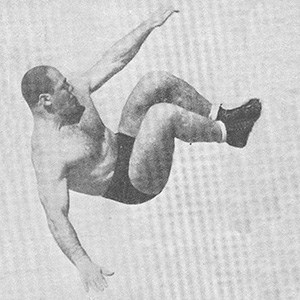 Man jumping and flying through the air feet first. Photo.
