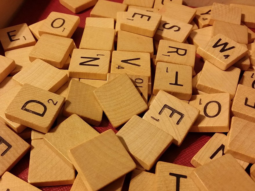 Heap of wooden  scrabble-letters. Photo.