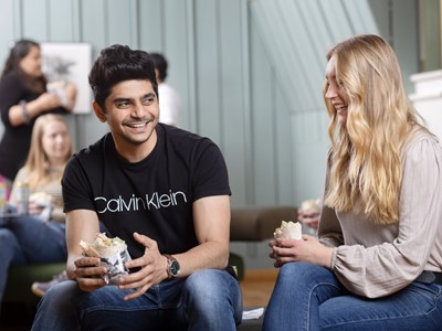 Students eating and laughing