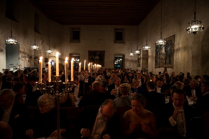 A candlelit banquet in the ancient hall of Rikssalen at Uppsala castle.