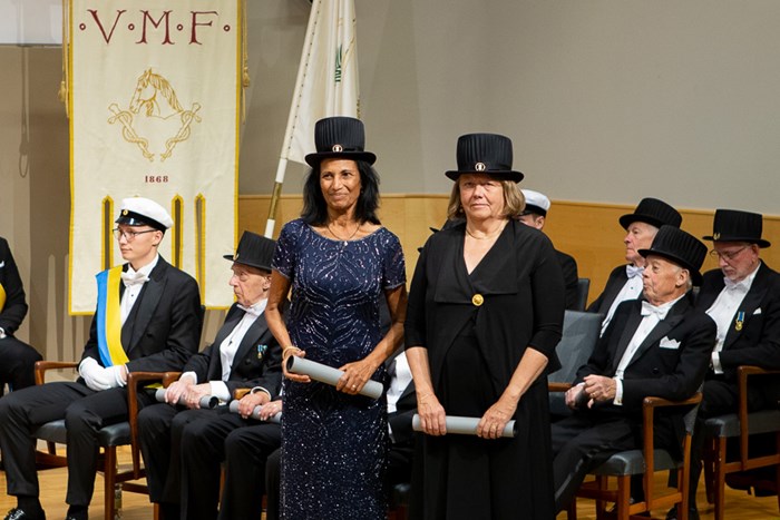Shakuntala Thilsted and Madeleine Fogde on stage wearing their doctor's hats.