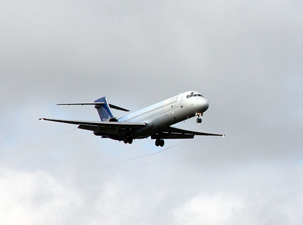 An aeroplane lifts in grey blue sky. Photo.