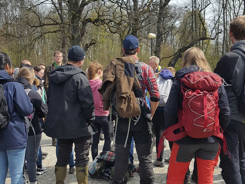 A large group of people outdoors with backpacks, photo.