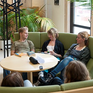 Students sitting in a couch, photo.